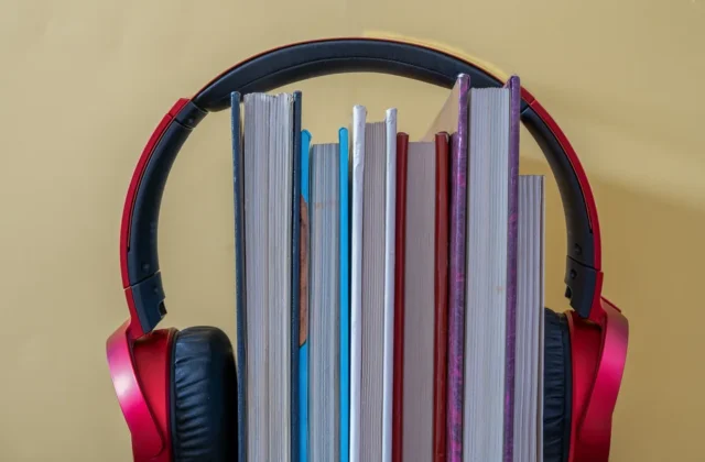 Creative setup of books with headphones symbolizing audiobooks and learning.